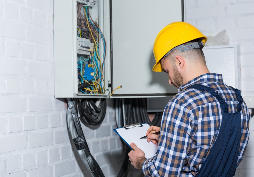 professional-electrician-inspecting-wires-in-electrical-box.jpg